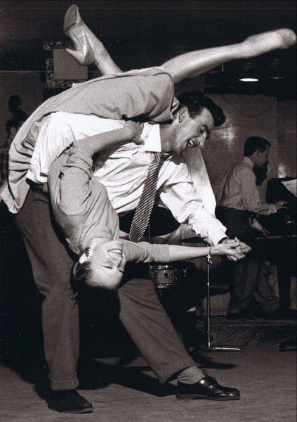 A man dancing with a woman. Black and white photo