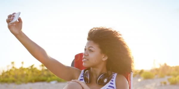 Girl Taking Self-Portrait with Smartphone at Beach