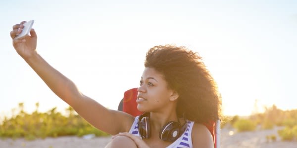 Girl Taking Self-Portrait with Smartphone at Beach