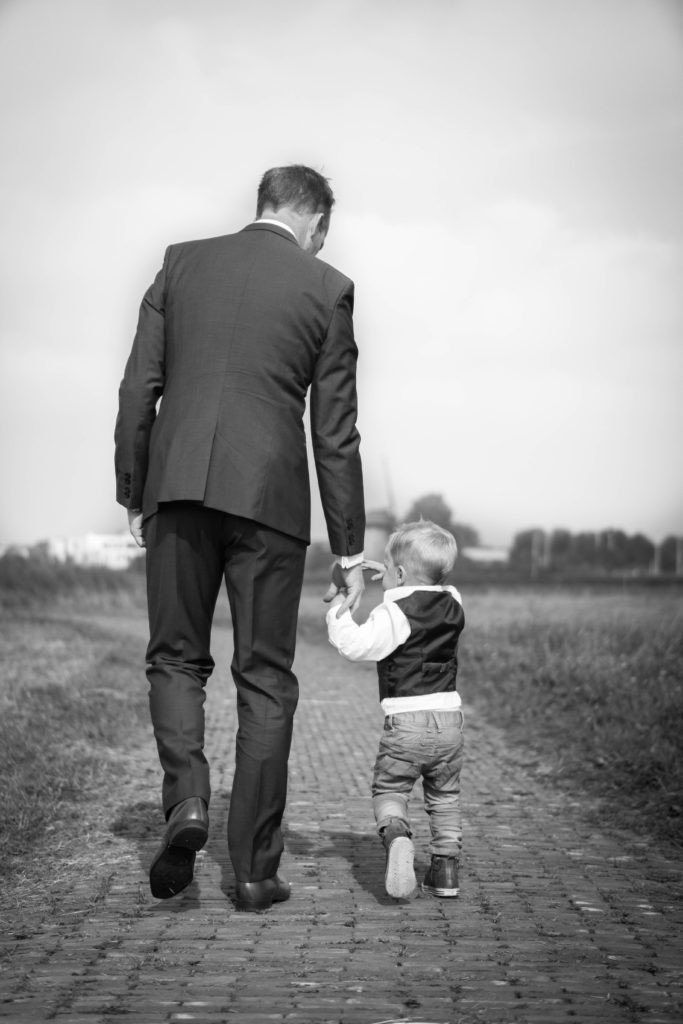 A man walking with his infant son