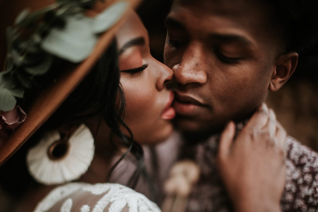 Black woman kissing a black man