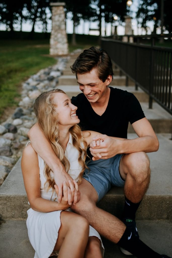 Young white couple holding hands in a park