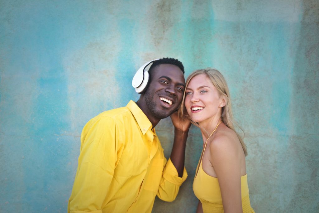 Black man listening to music with white girl