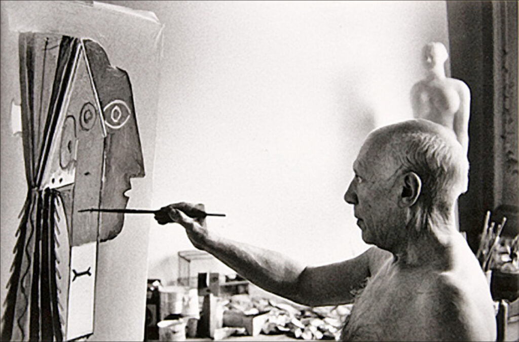 Picasso painting in his studio