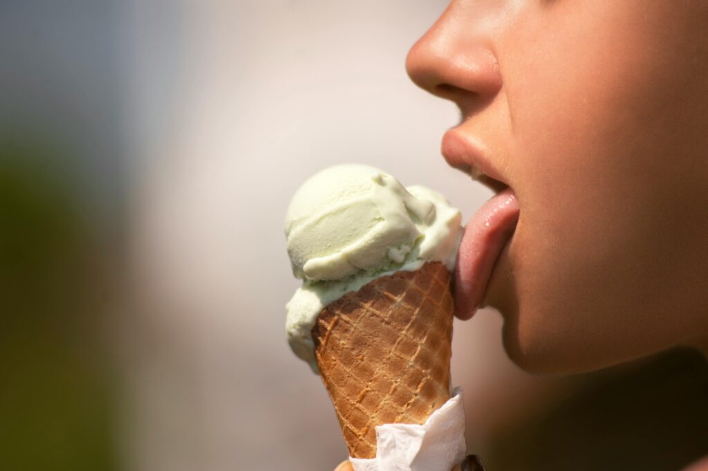 Woman licking an ice cream cone