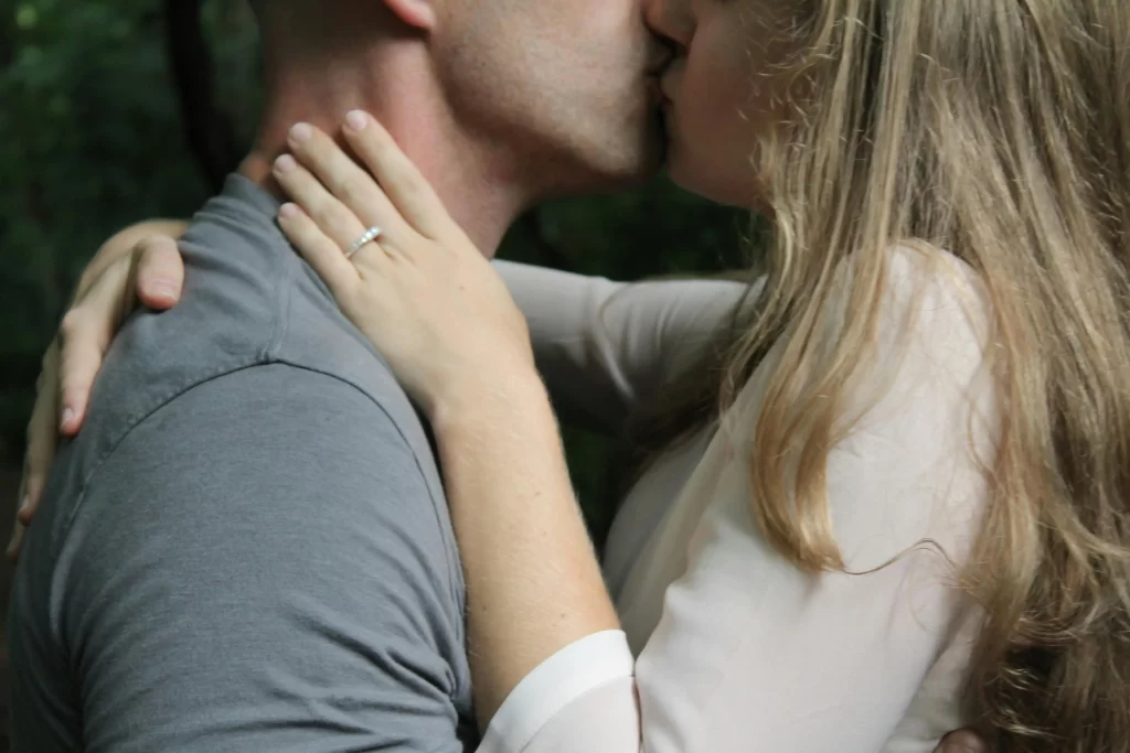 Man kissing a blond woman